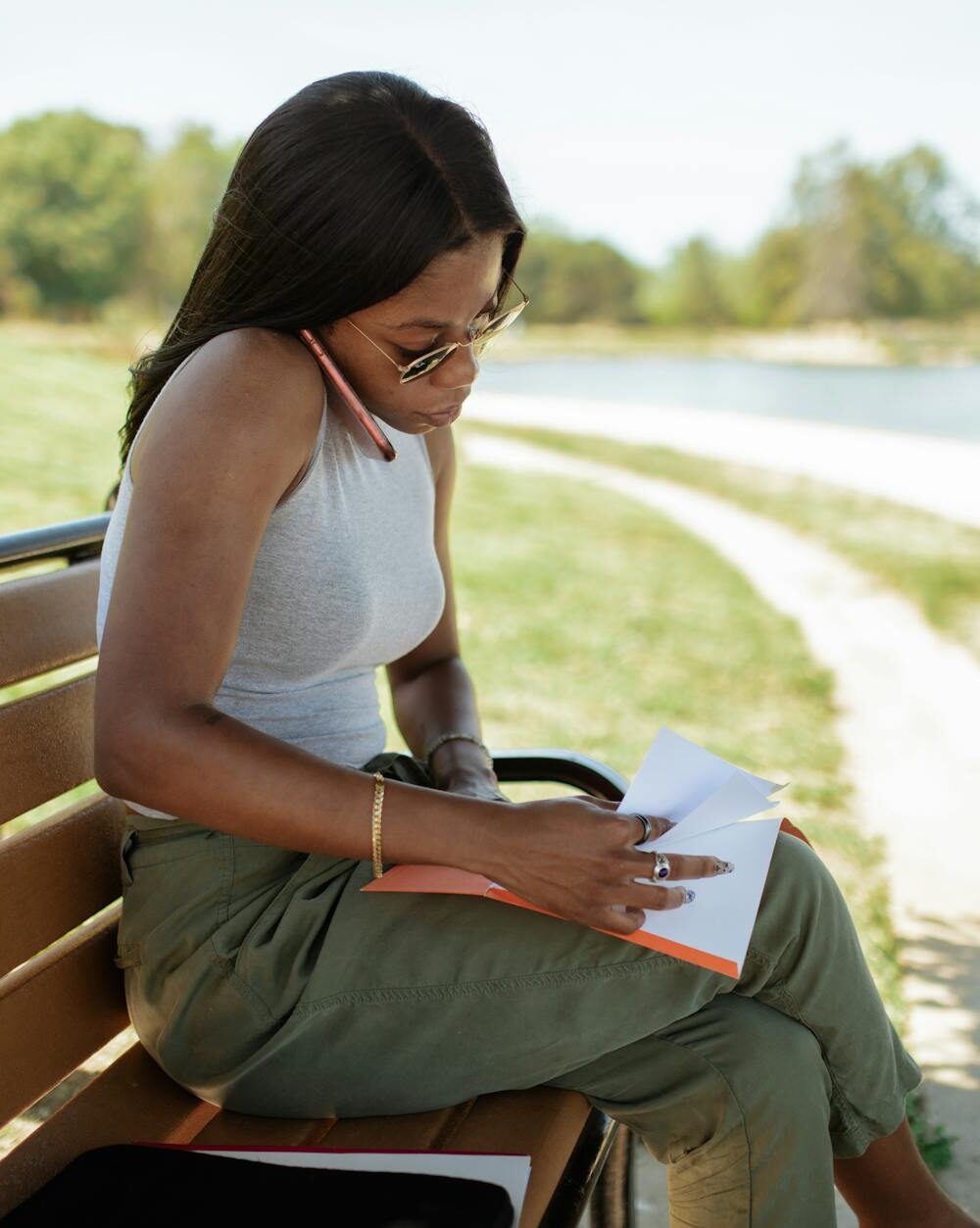 woman checking documents while talking on the phone