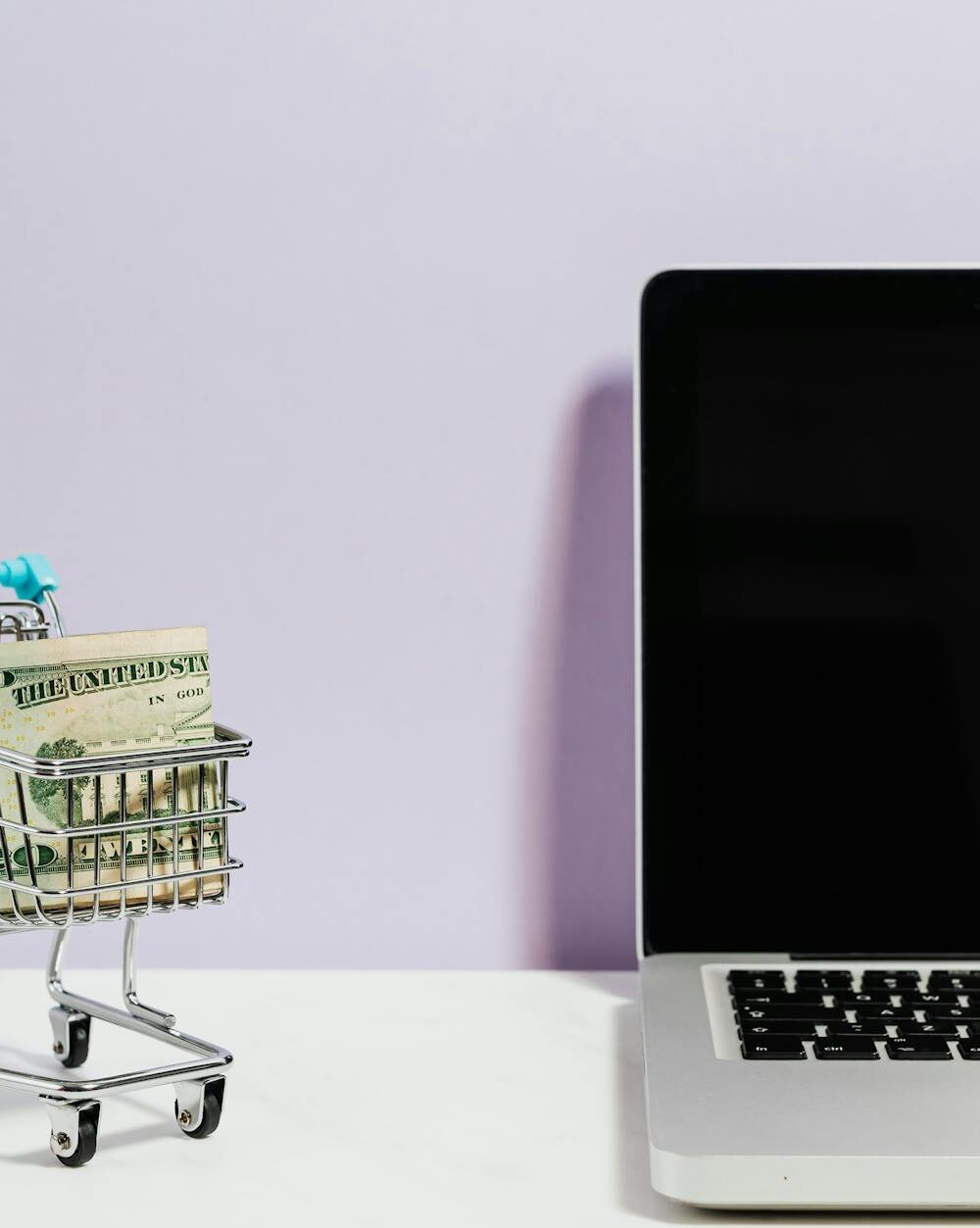shopping cart next to a laptop