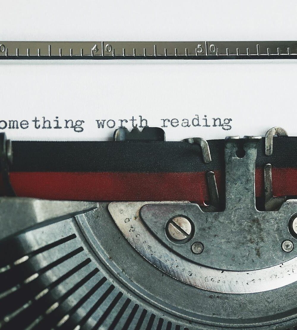 black and red typewriter on white table