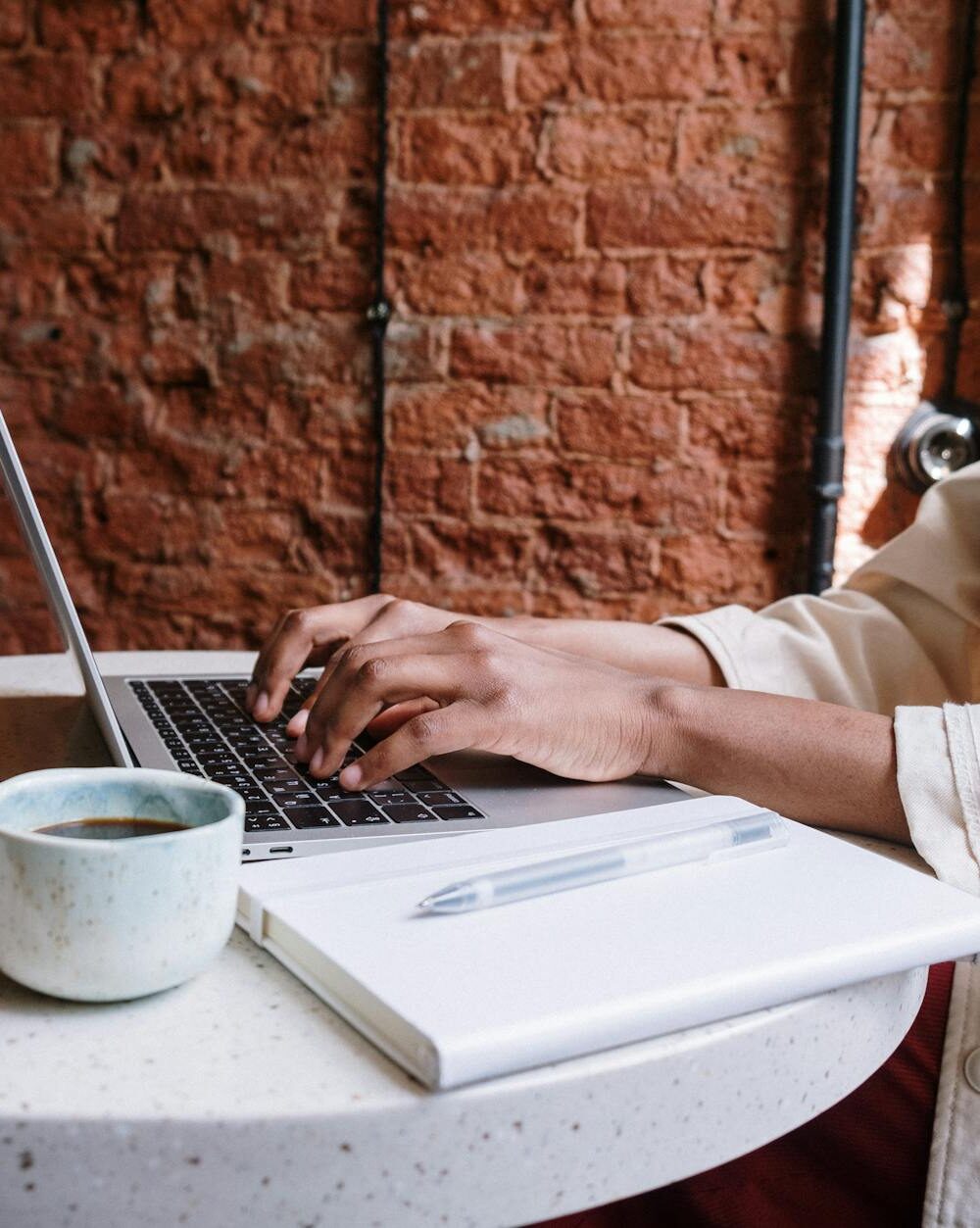 person in white long sleeve shirt using macbook pro