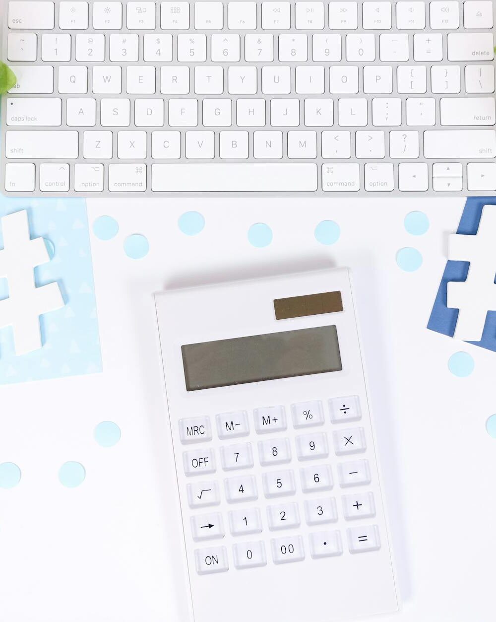 white and black calculator on white and blue textile