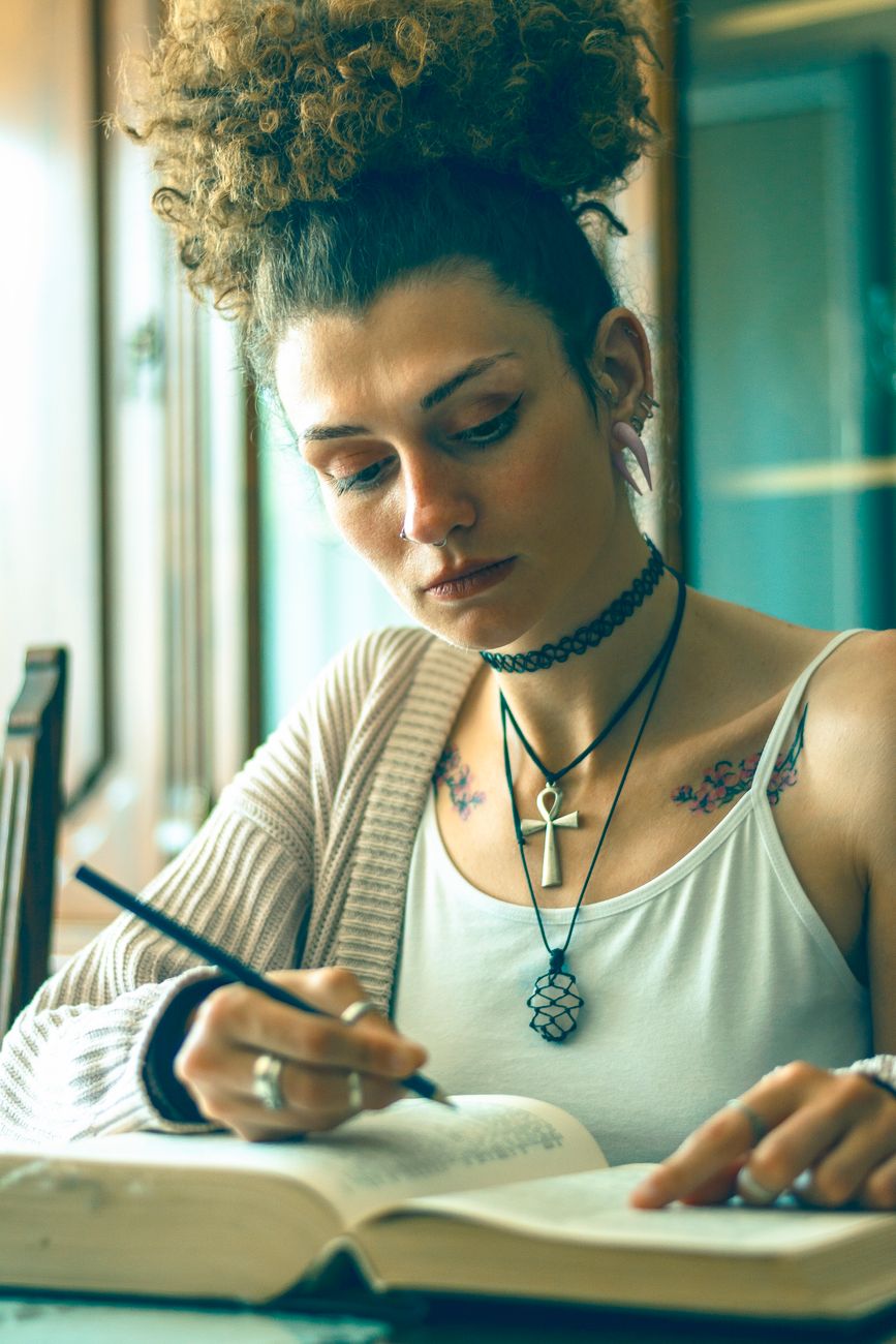 tattooed woman studying