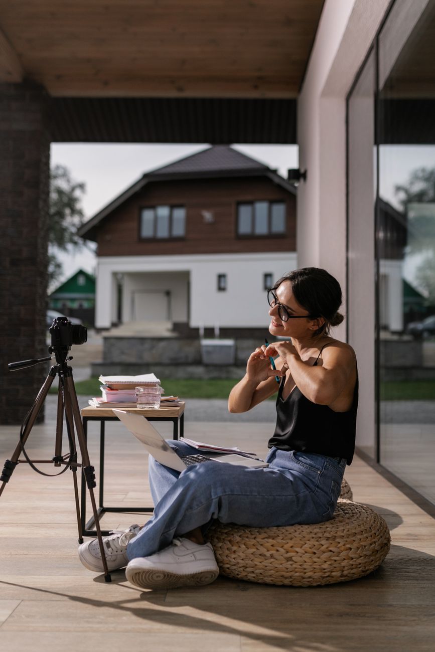 woman sitting with laptop and camera